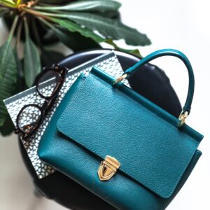 blue leather handbag on black leather bag